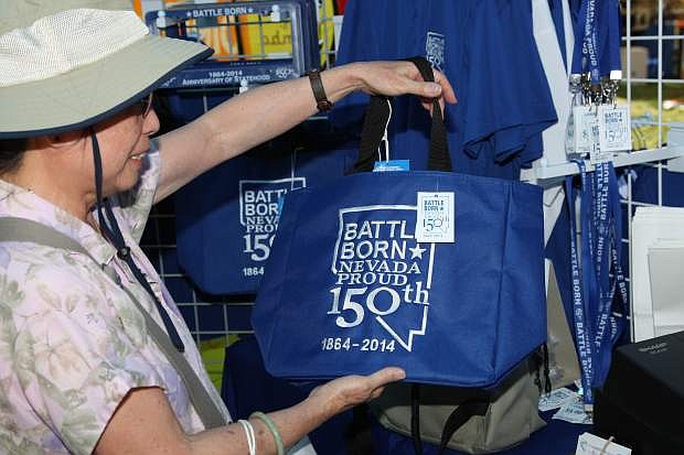 Phyllis Askew of Carson City purchases a NV150 bag at the fair Saturday.