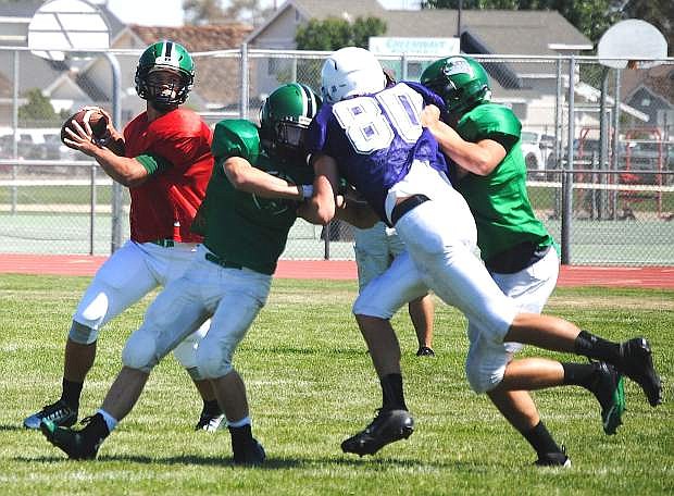 Fallon senior quarterback Joe Pyle, left, looks to throw during the Wave&#039;s scrimmage against Spanish Springs on Saturday.