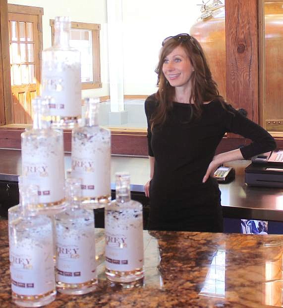 Ashley Frey stands behind bottoles of the Frey Ranch Gin, which officially rolls out on Saturday at a tasting event.