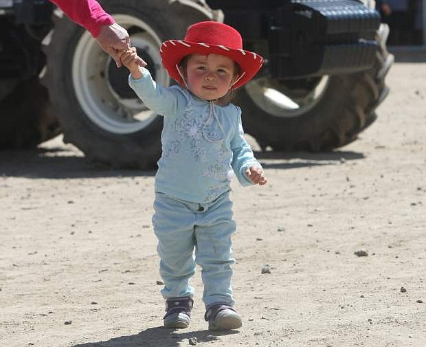 Two-year-old Aria Fong walks around Fuji Park on Friday during Capital City Farm Days.