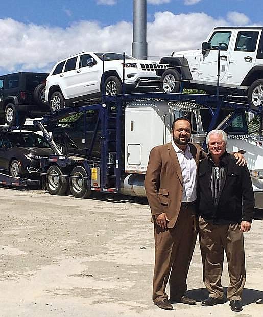 Moe Golshani (left) and Don Weir pose on the lot of Fernley Chrysler Dodge Jeep Ram dealership,