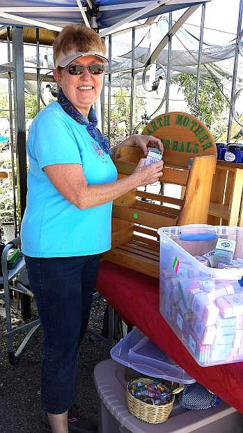 Patty Gonzales, a Certified Clinical Aromatherapist of Fernley, sets up her Earth Mother Herbals booth at the Fernley Farmers Market.