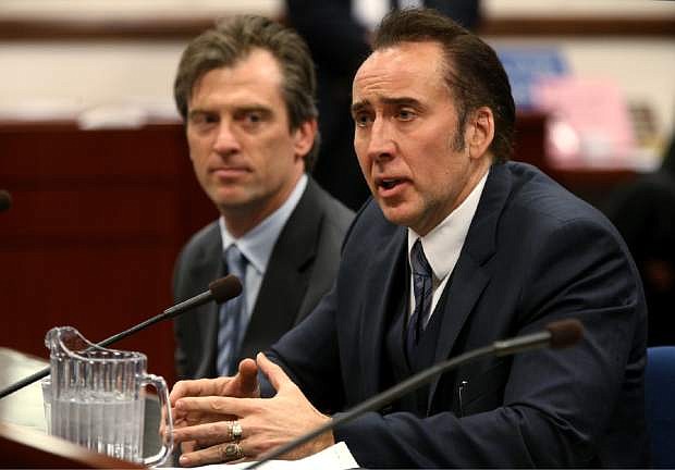 FILE - In this Tuesday, May 7, 2013 file photo, actor Nicolas Cage testifies in support of a bill proposing tax incentives to filmmakers at the Legislative Building Carson City, Nev. Cage&#039;s agent Michael Nilon is at left. Nevada lawmakers are hoping to breathe new life into a film tax credits program that was gutted while the state worked to attract Tesla. The Senate Revenue Committee is scheduled to review SB94 on Friday, Feb. 20, 2015. The measure would remove a cap that limits the state to awarding $10 million over the four years of the program, and would allow the Legislature to adjust that number.(AP Photo/Cathleen Allison)