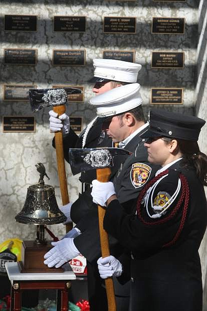 Members of the North Las Vegas and Cark County honor guards ring the bell as part of the Nevada Firefighters Memorial induction ceremony on Saturday at Mills Park. Fallen firefighters Dean Tajima of the North Las Vegas Fire Department and Paul Young of the Clark County Fire Department were honored.