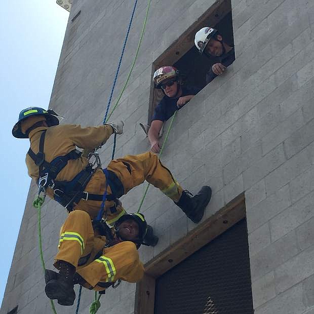 Students at the Fire Academy rappel down the training tower at the Carson City fire station Wednesday. The men had to practice rappelling from the top of the tower and save a &#039;victim&#039; from one of the windows.