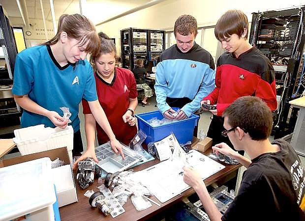 Northern Nevada high school robotics team members, from left, Jamie Poston, 17, Nadya Dolley, 16, Brandon Villar, 16, Price Poston, 15, and Alex Selop, 15, participate in the kick-off event of the FIRST Tech Challenge at Western Nevada College on Saturday.