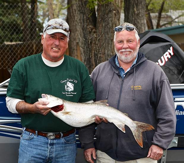 John Ternau and Rick Leiser, both of Carson City, hold their $100 prize-winning fish Saturday outside of Timbers Saloon. Their 10 lb. Mackinaw was caught off of Cave Rock during the Tom Brooks Memorial Fishing Derby. The pair also won $500 for most total weight of all their fish caught.