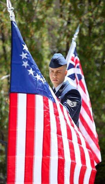 Alex Millar, a member of the Nevada Air Guard displays the Betsy Ross flag during the Five Flag presentation at the annual Flag Day ceremony on Tuesday.