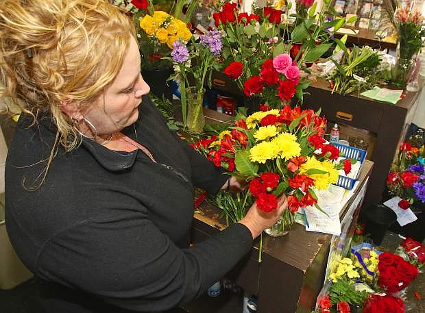Designer Kirsten Newbury arranges some flowers to be delivered for Valentine&#039;s Day Friday at the Flower Bucket on Carson St. The store is open until 6 p.m. both today and on Valentine&#039;s Day Sunday for last minute gift buyers.