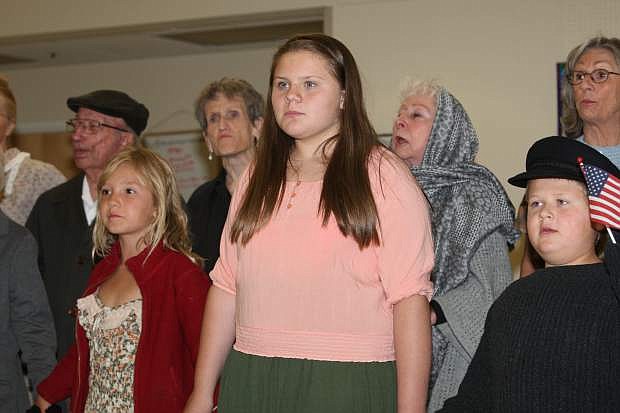 (Front Row, L-R) Sofie Kolupaeva, 7, Vanessa Norris, 11 and Tyler Fratis, 6, rehearse the opening number &quot;Isle of Hope, Isle of Tears,&quot; a song about immigrants entering America at the Senior Center on Thursday.