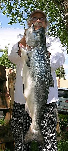 Charlie Abowd holds up a wild salmon.