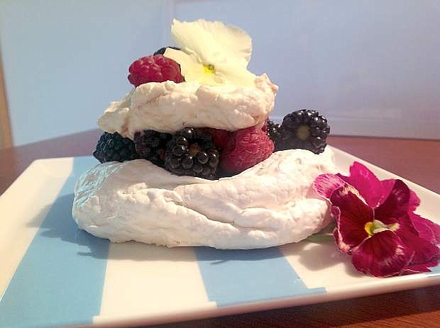 Pavlova is a  meringue nest, with a bit of crunch on the outside and a creamy, marshmallow-like inside, holding berries and cream. It was created for ballerina Anna Pavolova.