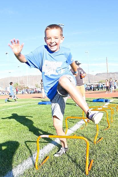 Junior Pee Wee Pop Warner football player Robert Henn, 10, runs an obstacle course Friday evening during the &#039;Friday Night Lights&#039; fundraiser held at Governor&#039;s Field.
