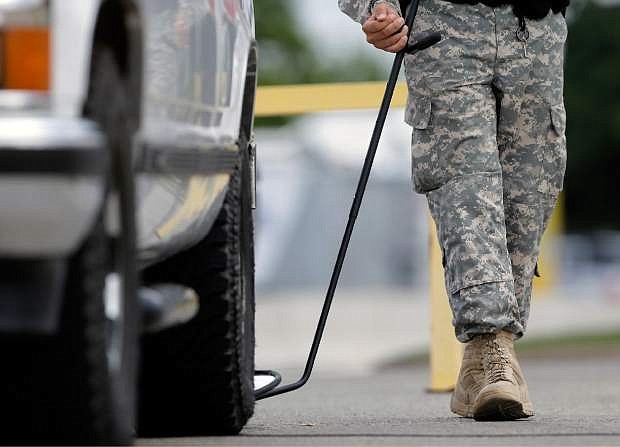 A mirror is used on a vehicle at a checkpoint to enter the Lawrence William Judicial Center as the sentencing phase for Maj. Nidal Hasan begins, Monday, Aug. 26, 2013, in Fort Hood, Texas. Hasan, who was convicted of killing 13 people in the November 2009 attack at Ford Hood, faces the death penalty as the sentencing phase of his trial begins Monday. (AP Photo/Eric Gay)