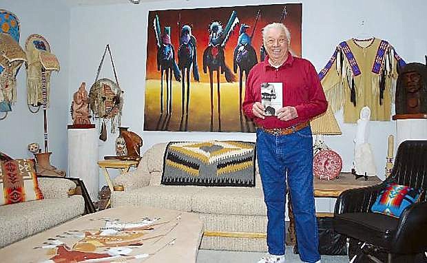 Adam Fortunate Eagle displays his book, &quot;Pipestone: My Life in an Indian Boarding School,&quot; at his Fallon home in 2012.