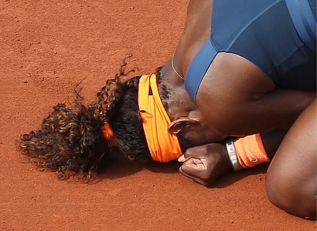 Serena Williams, of the U.S, celebrates on the clay as she defeats Russia&#039;s Maria Sharapova during the Women&#039;s final match of the French Open tennis tournament at the Roland Garros stadium Saturday, June 8, 2013 in Paris. Williams won 6-4, 6-4. (AP Photo/David Vincent)
