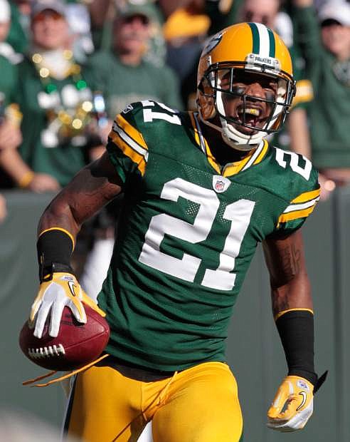 FILE - In this Sunday, Oct. 2, 2011 file photo, Green Bay Packers cornerback Charles Woodson (21) reacts after running back an interception for a touchdown during the first half of an NFL football game against the Denver Broncos, in Green Bay, Wis. Most of the big names hitting NFL free agency in 2013 aren&#039;t big stars anymore. While Ed Reed is coming off a Super Bowl season in Baltimore and Wes Welker catches 100 passes every year, this crop is more about aging defensive players such as Woodson, Brian Urlacher and Ronde Barber. (AP Photo/Mike Roemer, File)
