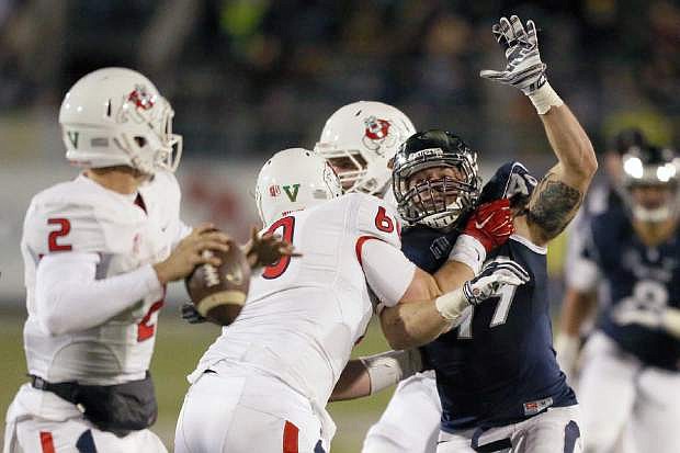 Nevada&#039;s Jordan Dobrich (49) tries to block a pass from Fresno State&#039;s Brian Burrell (2) during the second half of an NCAA college football game in Reno, Nev., on Saturday, Nov. 22, 2014. (AP Photo/Cathleen Allison)