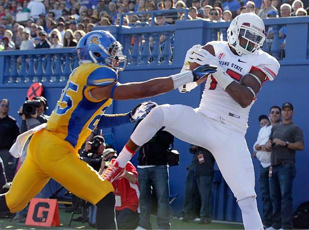 Fresno State wide receiver Davante Adams (15) catches a touchdown pass over San Jose State cornerback Akeem King (25) during the first half of an NCAA college football game on Friday, Nov. 29, 2013, in San Jose, Calif. (AP Photo/Tony Avelar)