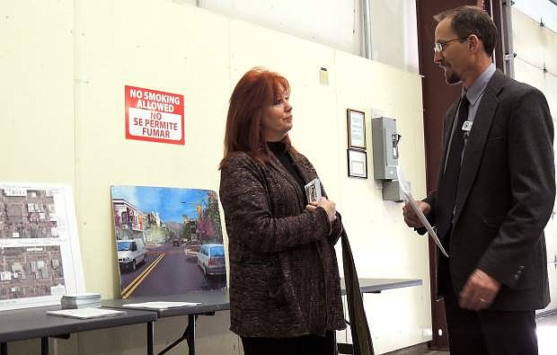 Downtown 20/20 President Dana Lee Fruend talks with Community Development Director Lee Plemel in front of the display set up for the downtown Carson Street project.