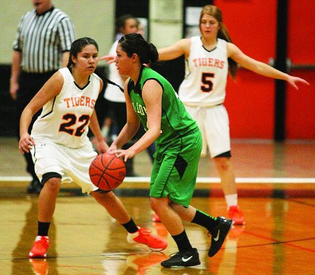 Lady Wave guard Shelby Smith works around a Douglas defender during Saturday&#039;s game.