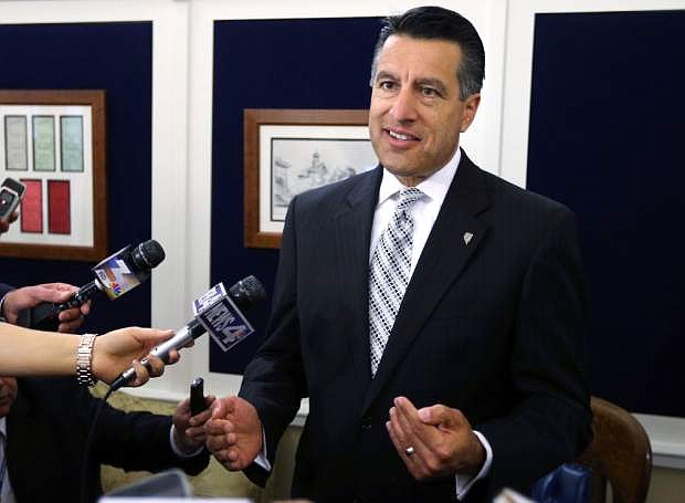 File-This June 4,2013 file photo shows Nevada Gov. Brian Sandoval answers media questions following a special Legislative session in Carson City, Nev. When Republican governors in November gathered in Las Vegas to discuss how to recover from their party&#039;s latest electoral drubbing, the popular GOP governor of Nevada wasn&#039;t there. Instead, Sandoval was in Washington, D.C., meeting with Obama administration officials to seal the deal that made him the first Republican governor to expand Medicaid as part of the president&#039;s health care initiative. (AP Photo/Cathleen Allison,File)