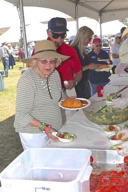 Joan Reid of Carson City helps herself to a plate of Basque food Saturday at Corley Ranch.
