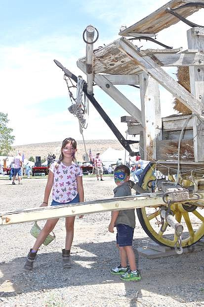 Deliala Burke, 7 1/2, and her 3 1/2 brother Keenan of Sparks play near an old wagon Saturday at Corley Ranch.