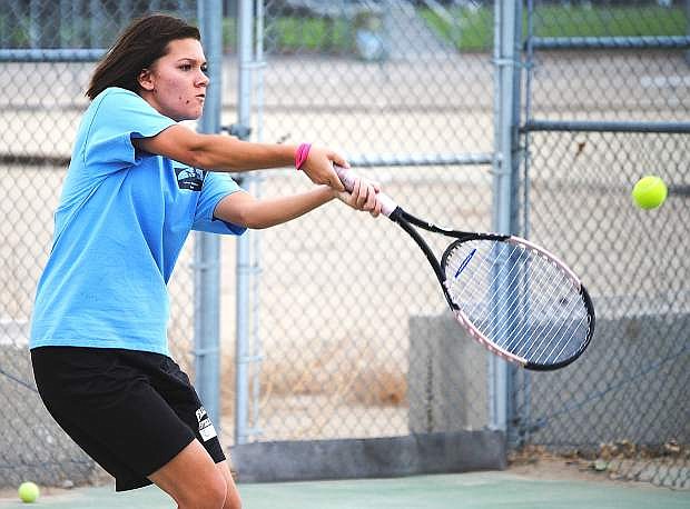 Senior Becky Conner hits a backhand during practice last week. Conner qulaified for the state tournament last season.