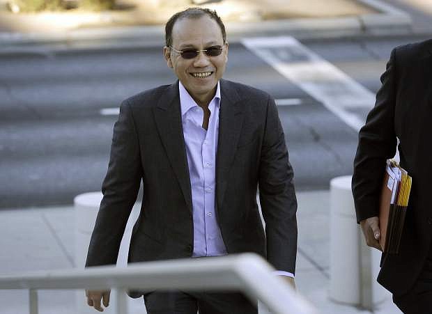 FILE - In this Nov. 6, 2014 file photo, Wei Seng Phua walks into federal court in Las Vegas. Phua, his son Darren Wai Kit Phua, and four others were arrested in July after federal agents raided three high-roller villas at Caesars Palace in Las Vegas. Five defendants are poised to take plea deals. That&#039;ll leave Phua and his son, to face trial on charges including operating an illegal gambling business during the World Cup soccer tournament. (AP Photo/John Locher,File)