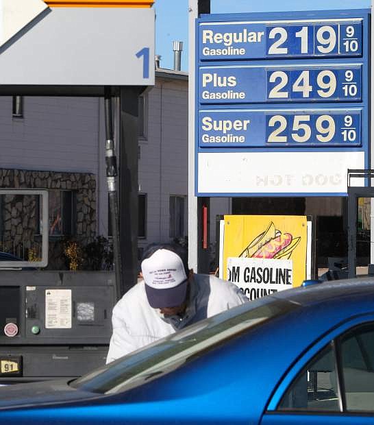 A motorist gets gas at JM Gasoline, which has one of the lowest prices for fuel in Carson City.