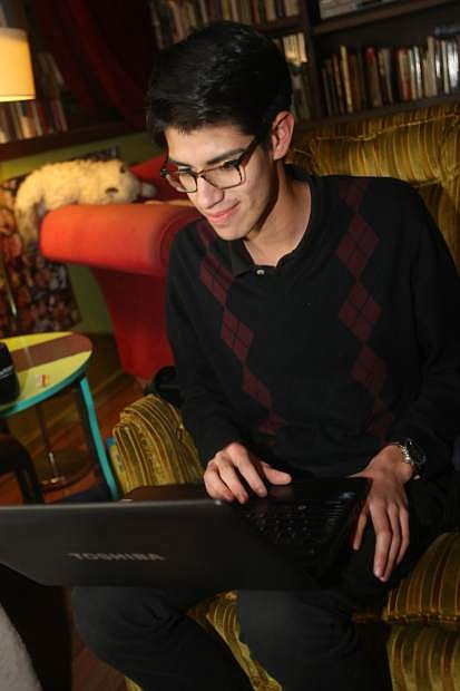 Carson High School senior Porfirio Jauregui works on his laptop at Comma Coffee on Wednesday.
