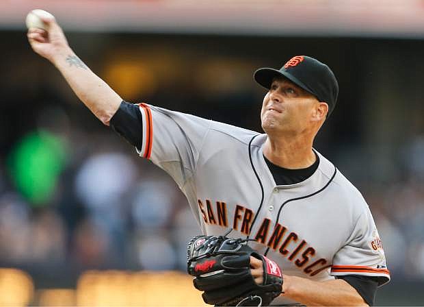 San Francisco Giants starting pitcher Tim Hudson works against the San Diego Padres in the first inning of a baseball game Saturday, April 19, 2014, in San Diego.  (AP Photo/Lenny Ignelzi)