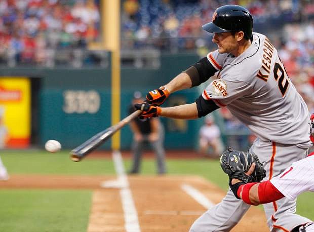 San Francisco Giants&#039; Roger Kieschnick hits a single that scored Buster Posey from third base during the third inning of a baseball game against the Philadelphia Phillies, Wednesday, July 31, 2013, in Philadelphia. (AP Photo/Tom Mihalek)