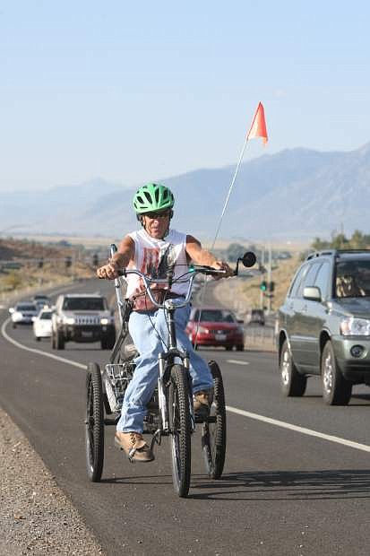 Glenn Lucky rides north on Highway 395 near Sunridge on Thursday morning.