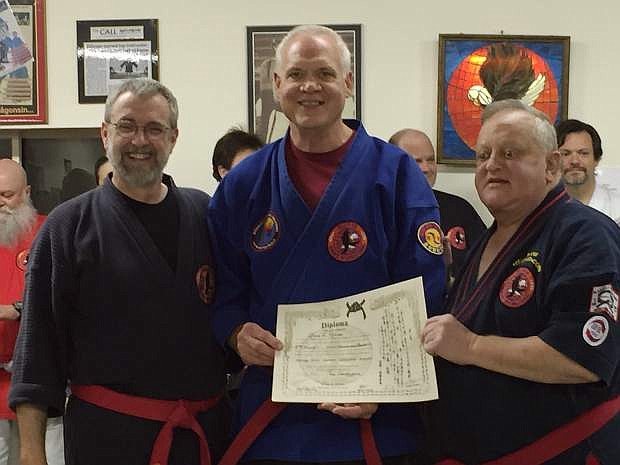 Local martial artist Glenn Ristine recently attended the Muhammad Ali Training Camp in Deer Lake, Pa., where he was promoted to the rank of 8th degree black belt, Grandmaster. Pictured from the left are Grandmaster Chris Thomas, Ristine, and Professor George Dillman.