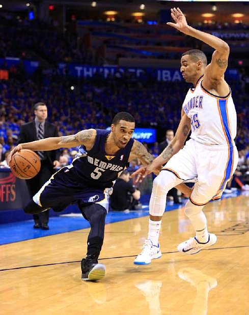 Memphis Grizzlies guard Courtney Lee (5) drives to the basket around Oklahoma City Thunder guard Thabo Sefolosha (25) during the first quarter of Game 1 of the opening-round NBA basketball playoff series in Oklahoma City on Saturday, April 19, 2014. (AP Photo/Alonzo Adams)