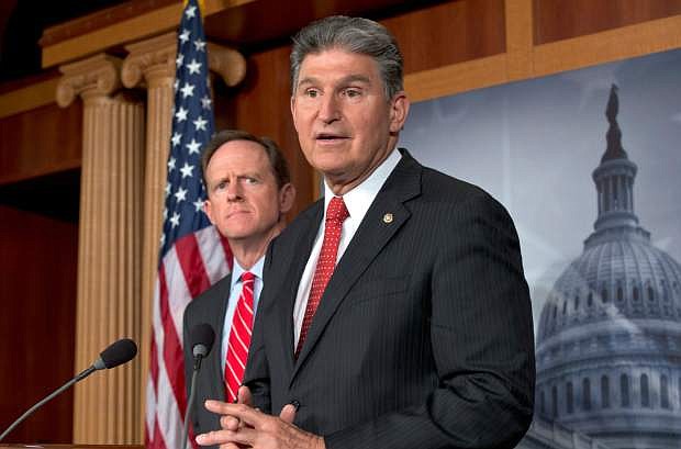FILE - In this April 10, 2013 file photo, Sen. Joe Manchin, D-W.Va., right, accompanied by Sen. Patrick Toomey, R-Pa., announce that they have reached a bipartisan deal on expanding background checks to more gun buyers,, on Capitol Hill in Washington. The number of Republican senators who might back expanded background checks is now dwindling, threatening a bipartisan effort to subject more gun buyers to the checks. A vote on the compromise, the heart of Congress&#039; gun control effort, is expected this week.  (AP Photo/J. Scott Applewhite, File)