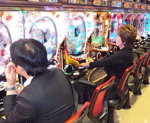 Pachinko gamblers try their luck at a parlor in central Kyoto, Japan.