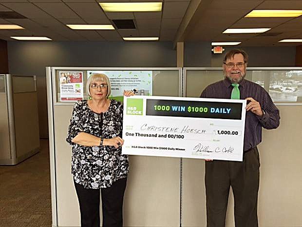 Christene Hoesch, a winner of the H&amp;R Block 1,000 Win $1,000 Daily Sweepstakes, celebrates at the Eagle Station Shopping Center H&amp;R Block office at 3853 S. Carson St. Tax Professional Rodney Bennett presents Hoesch her check during the festivities on Thursday.