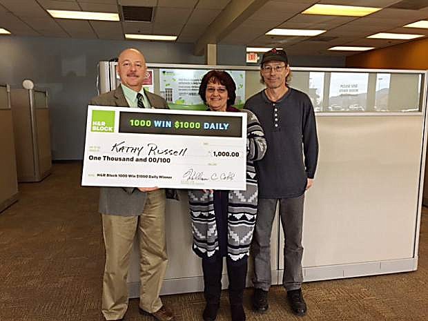 Kathy Russell, a local winner of the H&amp;R Block 1,000 Win $1,000 Daily Sweepstakes, celebrates with her husband, Joseph, at the Eagle Station Shopping Center H&amp;R Block office, 3853 S. Carson St. Office Manager Tony DeCrona presents Russell her check during the festivities on Tuesday.