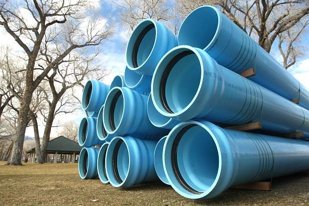 Large pipes are stored at Mills Park for a water and sewer project.