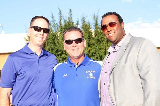 Two former Carson High Football players pose with Coach Blair Roman and were inducted into the Hall of Fame at the Kickoff and Hall of Fame Dinner Saturday. Class of 1999 graduate Dave Krueger (left) was an all-state running back and was also the Gatorade Player of the Year in Nevada. Class of 1998 graduate Justin Mitchell (right) was an all-state center his senior year.