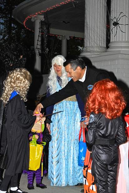 Gov. Brian Sandoval hands out candy on the front steps of the Governor&#039;s Mansion Friday night in Carson City.