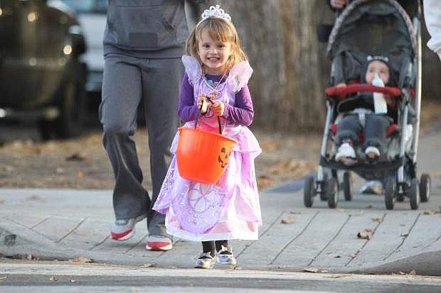 Three-year-old Anabella Congiusti walks on Mountain Street on Thursday evening to trick-or-treat at the governor&#039;s mansion.