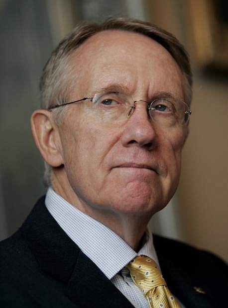 Senate Minority Leader Harry Reid, D-Nev., left, pauses during a news conference on Tuesday, Sept. 20, 2005 in Washington.  Reid announced that he will vote against Chief Justice nominee John Roberts.  (AP Photo/Evan Vucci)