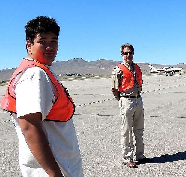 Carson City&#039;s Richard Frewert, Jr., foreground, with his father, Rick, behind him, as they head toward a refueling area at the Silver Springs Airport to help at a stop on the Hayward Air Rally. The younger Frewert is an aviation summer camp scholarship winner.