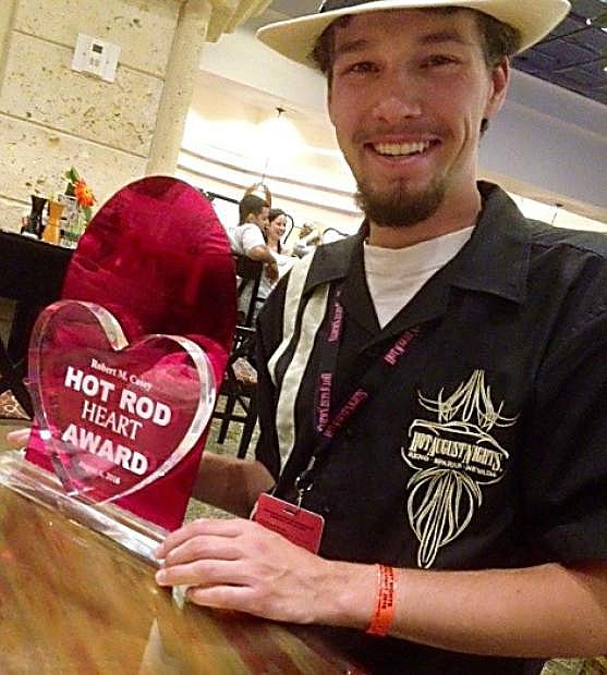 Peter Aylworth shows off the Robert M. Casey Hot Rod Heart Award, which honors the next generation of hot rod owners.