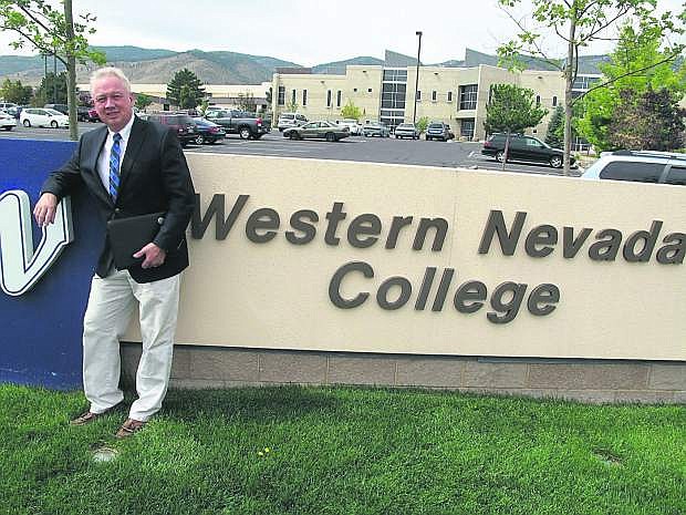 WNC President Chet Burton stands in front of the main campus sign in Carson City
