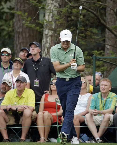 Jordan Spieth reacts to his tee shot on the 16th hole during the fourth round of the Masters golf tournament Sunday, April 13, 2014, in Augusta, Ga. (AP Photo/Charlie Riedel)